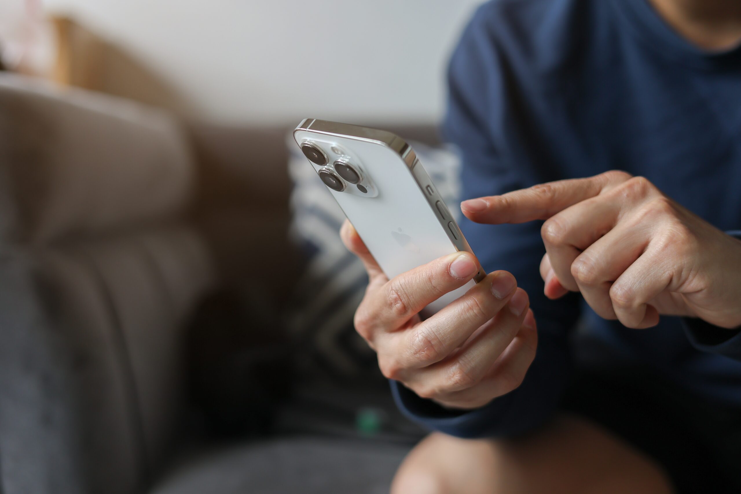 Person using iPhone to view social media